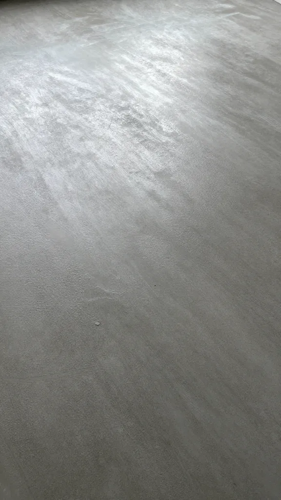 troweled concrete coop floor surface with slight moisture sheen